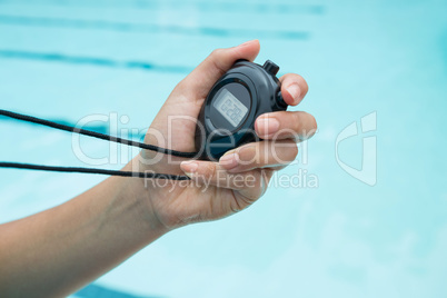 Hand of coach holding stopwatch