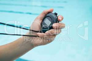 Hand of coach holding stopwatch