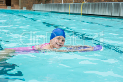 Smiling girl swimming in the pool