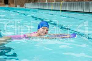 Smiling girl swimming in the pool