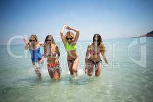Cheerful female friends enjoying in sea