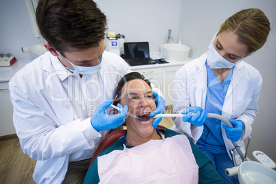 Dentists giving anesthesia to male patient