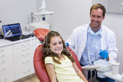 Portrait of smiling dentist and young patient