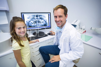 Smiling young patient and dentist in dental clinic