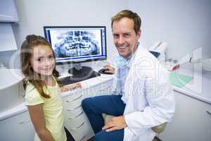 Smiling young patient and dentist in dental clinic