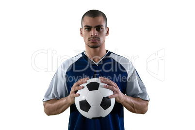 Football player holding football with both hands