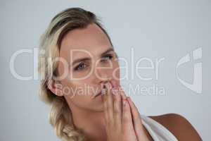Transgender woman with hands clasped