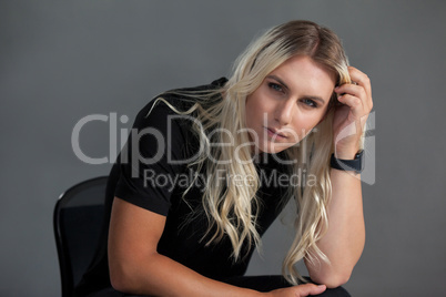 Portrait of transgender woman sitting on chair