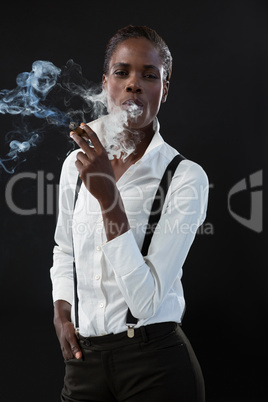 Androgynous man smoking a cigar