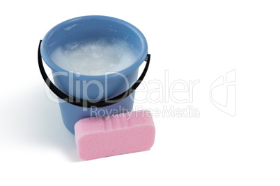 Sponge by bucket containing soap sud