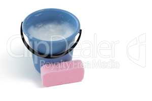 Sponge by bucket containing soap sud