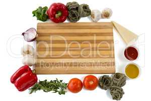 Overhead view of cutting board amidst various vegetables