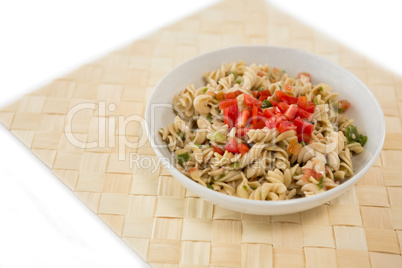 High angle view of rotini served in bowl on place mat