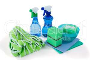 Close up of spray bottles with bowl and sponges