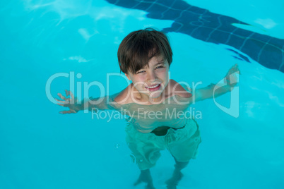 Smiling boy swimming in the pool