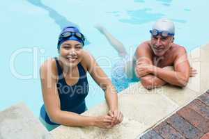 Smiling senior man and woman at poolside