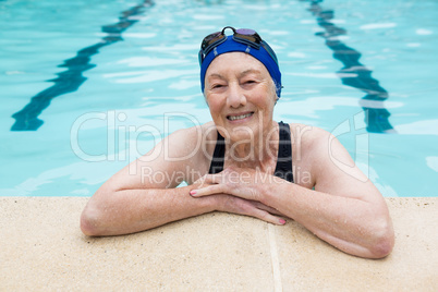 Smiling senior woman standing in swimming pool