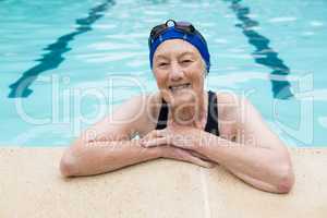 Smiling senior woman standing in swimming pool