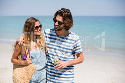 Happy couple standing on shore
