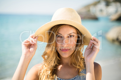 Beautiful young woman wearing sun hat