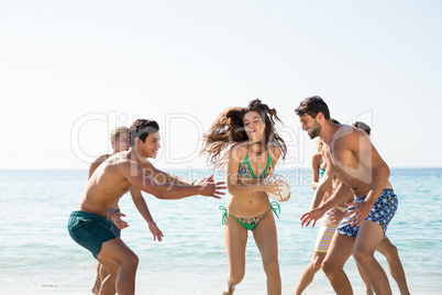 Friends playing on shore at beach