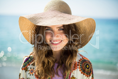 Portrait of happy young woman wearing sun hat