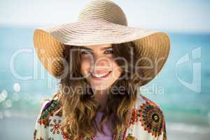 Portrait of happy young woman wearing sun hat