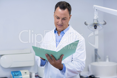 Dentist reading dental report