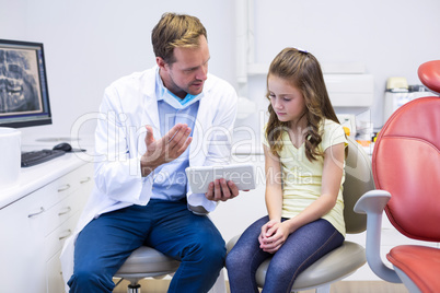 Dentist interacting with young patient