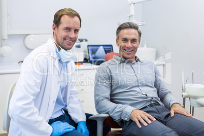 Portrait of smiling dentist and patient