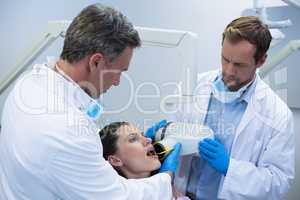 Dentists taking x-ray of patients teeth
