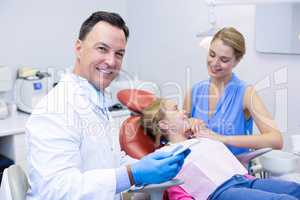 Dentist holding digital tablet in dental clinic