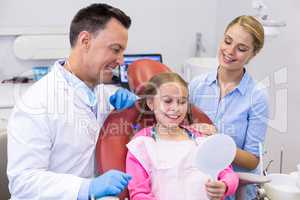 Young patient looking at mirror in dental clinic