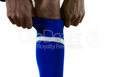 Football player pulling his socks up