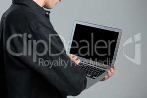 Androgynous man using laptop