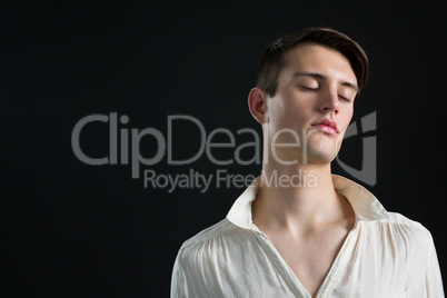 Androgynous man posing with his eyes closed