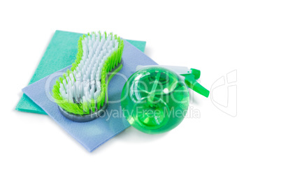High angle view of brush and spray bottle with wipe pad
