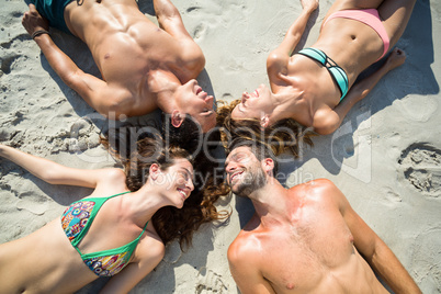 Happy friends sunbathing at beach