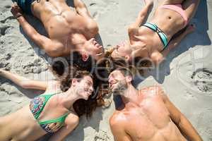 Happy friends sunbathing at beach