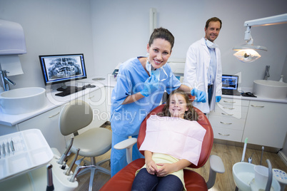 Portrait of smiling dentists and young patient