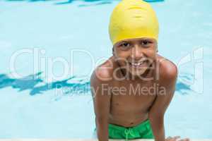 Smiling boy standing in swimming pool