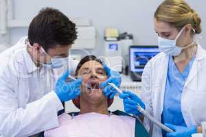Dentists giving anesthesia to male patient