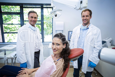 Portrait of smiling dentists and female patient