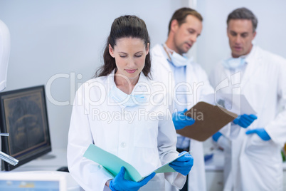Dentist looking at reports in dental clinic