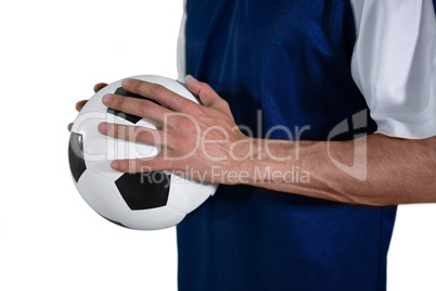 Mid-section of football player holding football with both hands