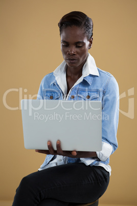 Androgynous man using laptop