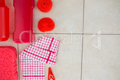 Overhead view of red cleaning products with napkin