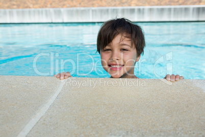 Little boy smiling in the pool