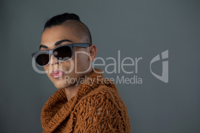 Transgender woman wearing sunglasses looking away