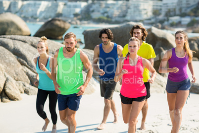 Friends jogging on shore